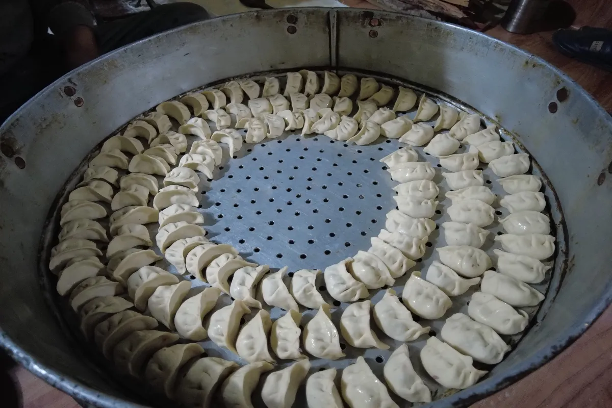 Cooking technique. making Asian steam dumplings or momo in traditional style